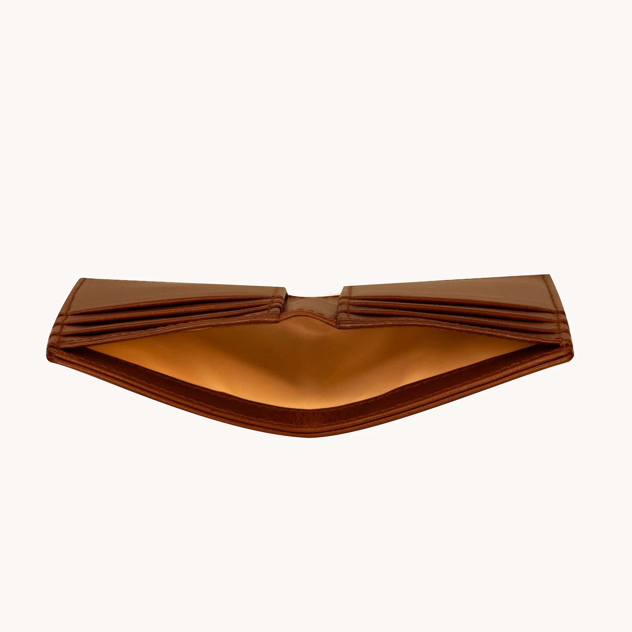 Lunburg Signet Vertical Bifold in Deep Mahogany, interior profile view showing the wallet opened at a low angle to reveal the card slot architecture on both sides and the goat leather lining of the central bill compartment, in vegetable-tanned Perpetual Leather (from Tempesti) with folded edge construction.