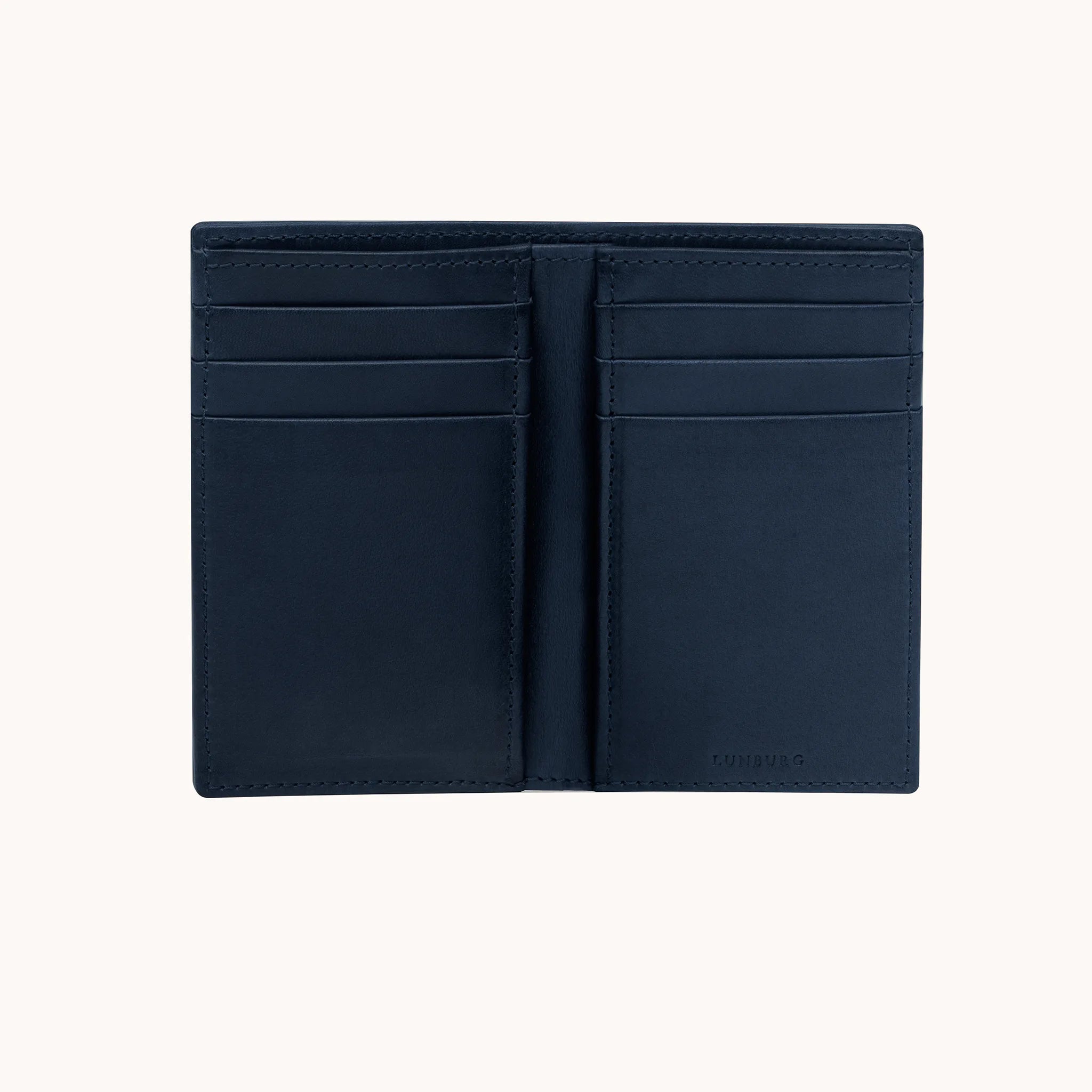 Lunburg Signet Vertical Bifold in Nocturnal Sapphire, fully open interior view showing card slots on both panels and the heat-embossed Lunburg mark on the lower right, in vegetable-tanned Perpetual Leather (from Tempesti) with folded edge construction throughout.